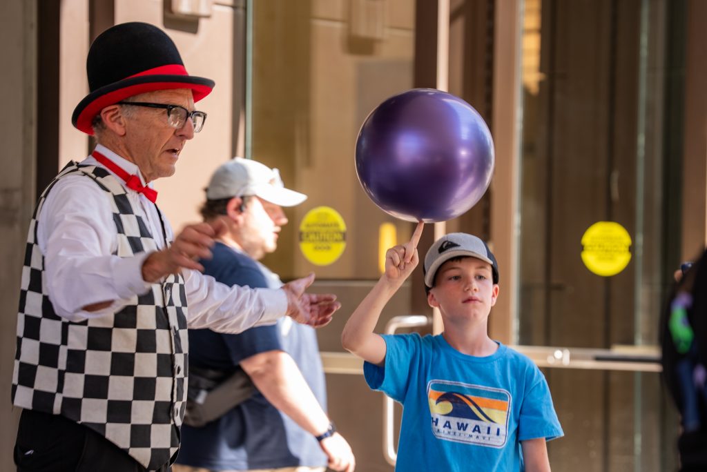 A boy watches a street performer at the Open Streets festival in downtown Salt Lake City.